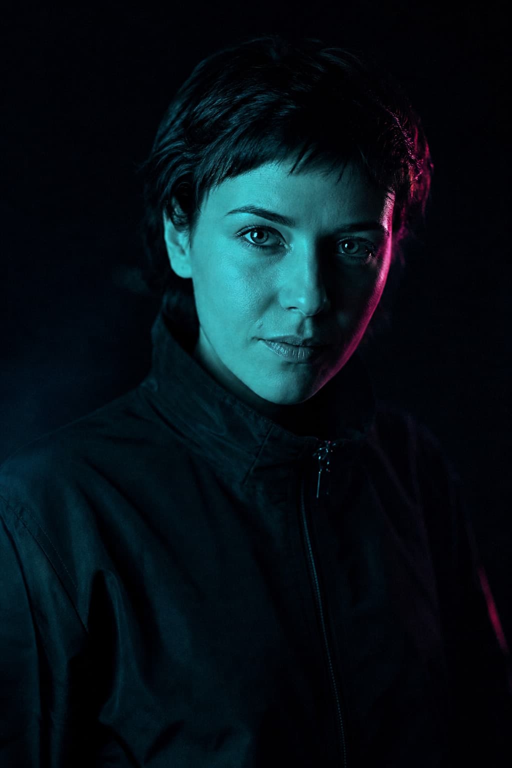 Nova Haller portrait lit by cyan light with a magenta rim